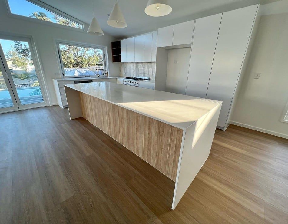 Empty Kitchen And Wooden Table — Luxury Home Builders in Gold Coast, NSW