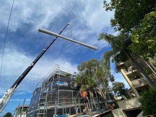 Crane Lifting Formwork On Site — Luxury Home Builders in Gold Coast, NSW