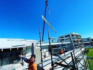 Framework Being Lifted Into Position — Luxury Home Builders in Gold Coast, NSW